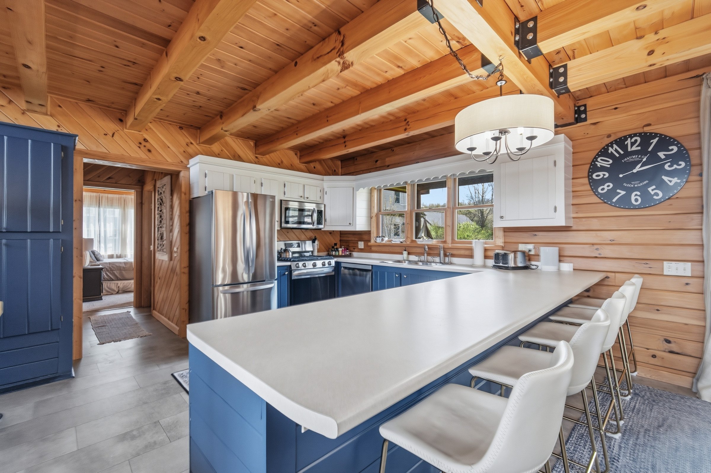 Main kitchen with blue island and farmhouse clock